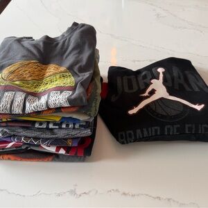 11 boys shirts all basketball related. Sizes from 7-8. One Jordan sweatshirt.